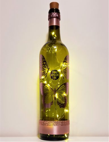 Bottle light with matte metallic pink butterflies and "you amaze me".