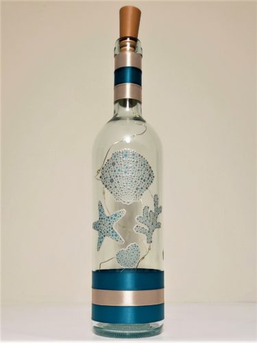 Bottle light with metallic silvery and teal seashells.